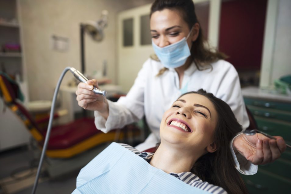 Smiling widely when the dentist finishes